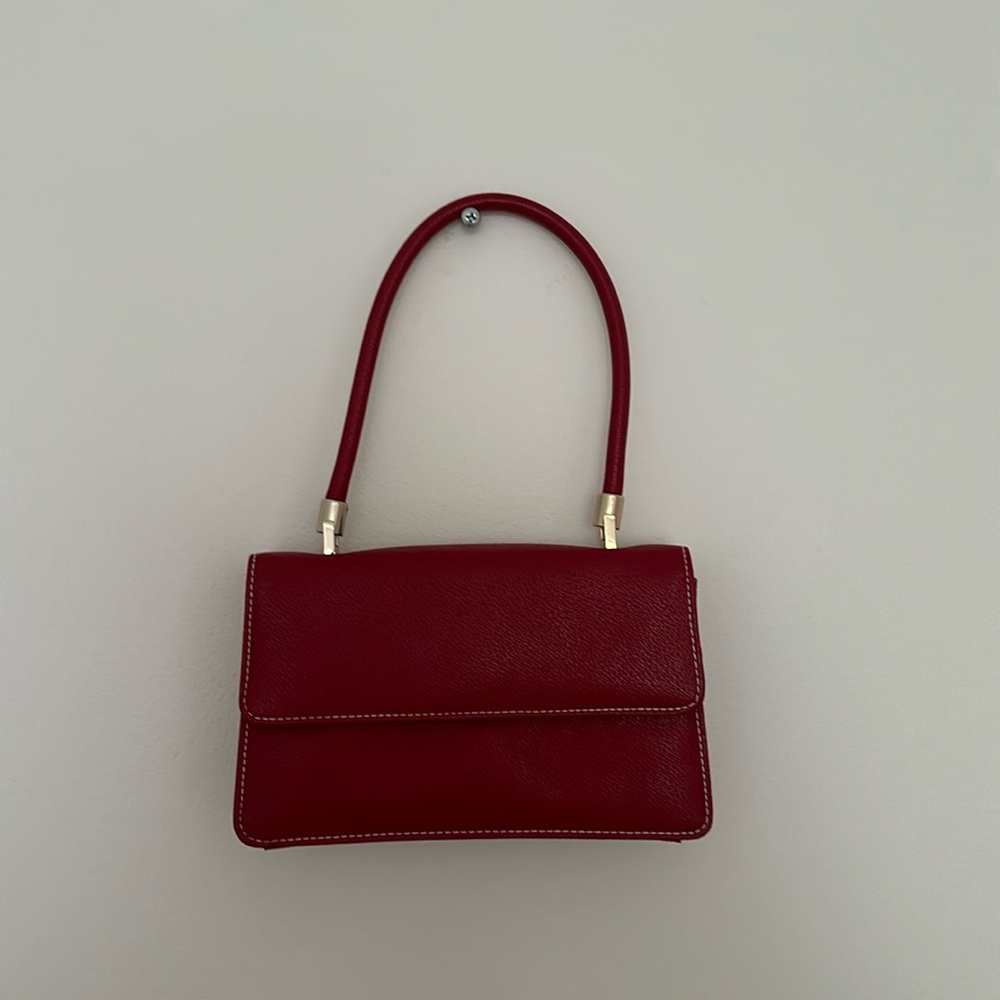 Small red top handle women’s purse with gold hardware
